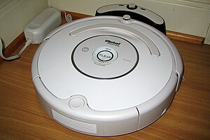 Figure 2: Roomba vacuum cleaner docked in base station [3].