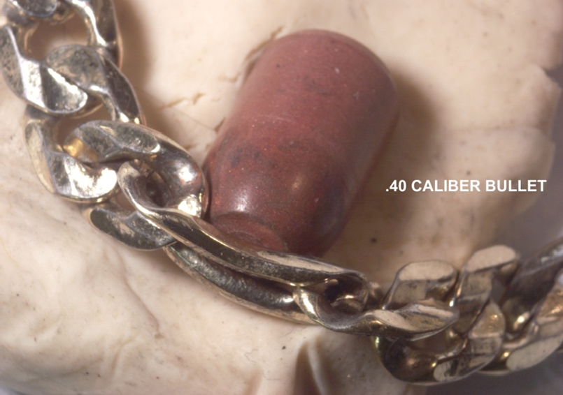 Figure 15: Simulation of a semiwadcutter FMJ .40 caliber bullet at the distorted link; this shows a fit of the flat bullet nose to the distorted bracelet link; apparent semiwadcutter bullets were involved in this shooting. Evidence item 14 bullet design is described as a “FMJ flat tip” ([1] p 103) which could be the bullet that hit Harris’ wrist/bracelet.