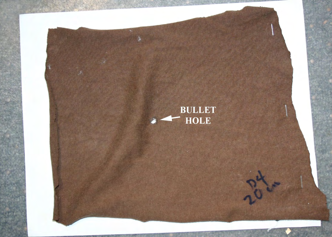 Figure 4: The test fabric was a worn t-shirt that was similar in weave and fabric thickness to Adam Owen’s t-shirt; the test fabric was fastened over Benchkote paper [3], which was attached to plywood and then shot with the .357 caliber Hornady cartridges in the S&W revolver.