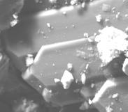 Figure 16: SEM images of sandstone recovered from BH(A) (depth=3827-3837m)showing a pore. The predominant clay type from SEM was kaolinite which was present in all the samples examined. Photographs from SEM showed quartz overgrowths in BH(A) core samples. Quartz, diagenetic mica, feldspar form the main pore filling mineral phase [9,10]. The presence of chlorite restrict pore throat and consequently reduce permeability [11,12]. Petrophysical evaluations with high clay as in case of BH(A) underestimate the saturation of hydrocarbons if the conductivity of the clays is not considered [13]. By contrast, porosity values could be overestimated when petro physicists do not have the appropriate understanding of the occurrence of the different clays through the formations, as each has a unique way of affecting porosity. The replacement of chlorite by calcite in the model changes the total porosity only slightly as the tool response parameters for the two minerals are very similar (i.e. chlorite and calcite have similar densities). However, the addition of chlorite does have a considerable impact on water saturation, and effective porosity [13]. The books of kaolinite present in both BH(A) and NH(B) reduces permeability in the porous media [14].