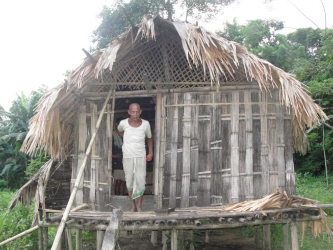Figure 3: A Mishing medicine man coming out from his house (Chang ghar).