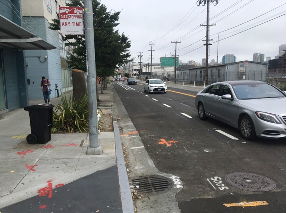 Figure 5: View of 7th Street farther north of previous images showing loss of parking and bike lanes. Street has been engineered to remove as much parking as possible and provide space for “safe” lanes for bikes. Traffic is squeezed into one lane in each direction. Design creates an opportunity for drivers to enter the bike lane to attempt to pass stopped traffic creating dangerous conditions.