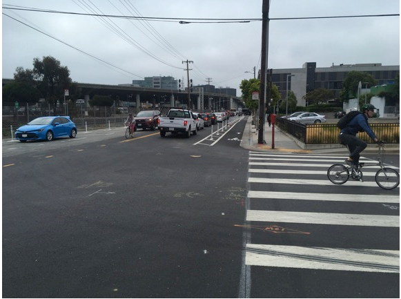 Figure 6: View of 7th Street showing cars parked in former curb lane and increased danger for drivers to exit their autos.