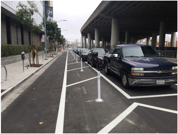 Figure 8: View of same intersection as in Figure 7 showing not only blocked view of oncoming traffic on 7th but also how traffic on oncoming lane cannot see bicycle riders in lane hidden by cars.